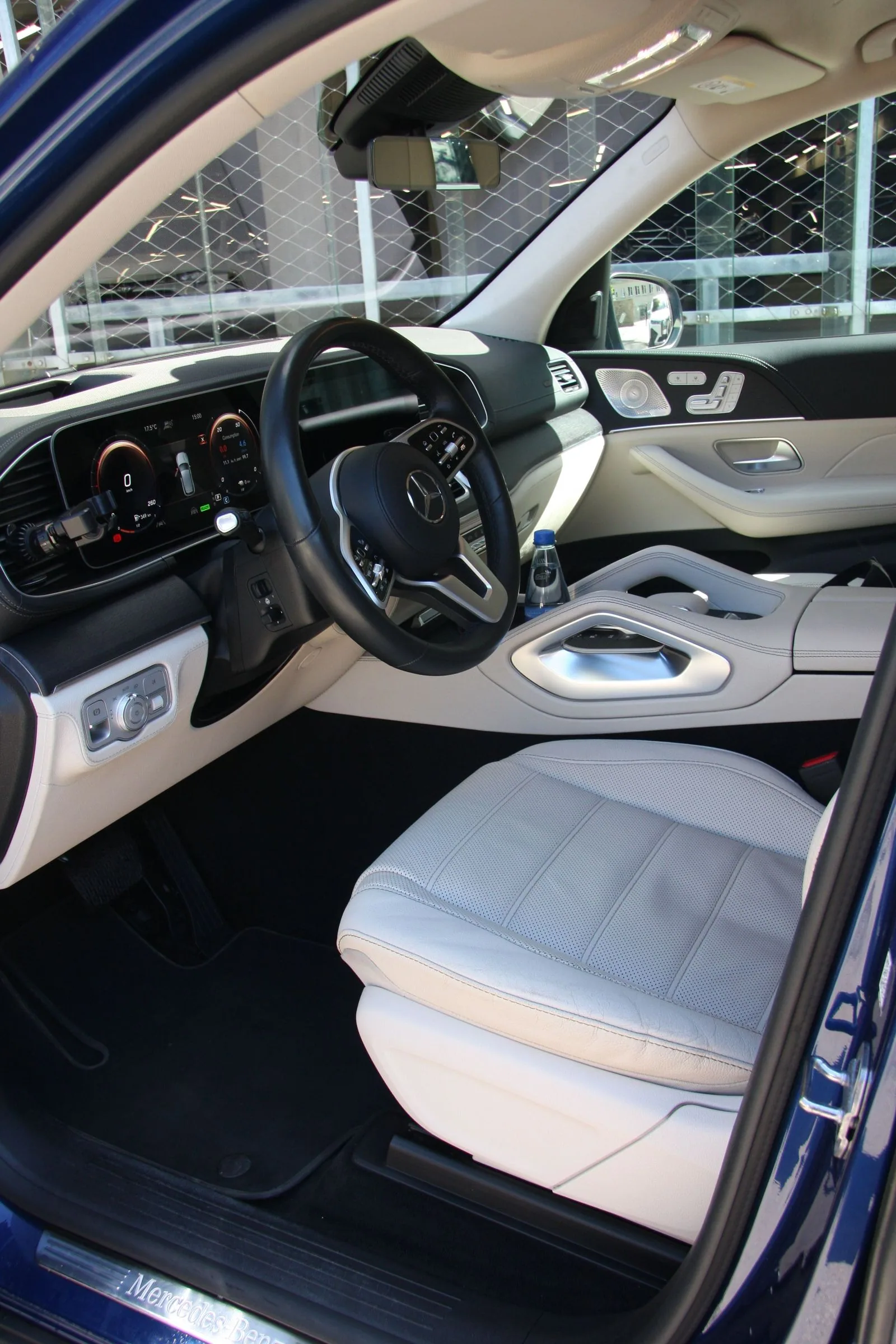 Clean light Mercedes-Benz interior and driver's area.