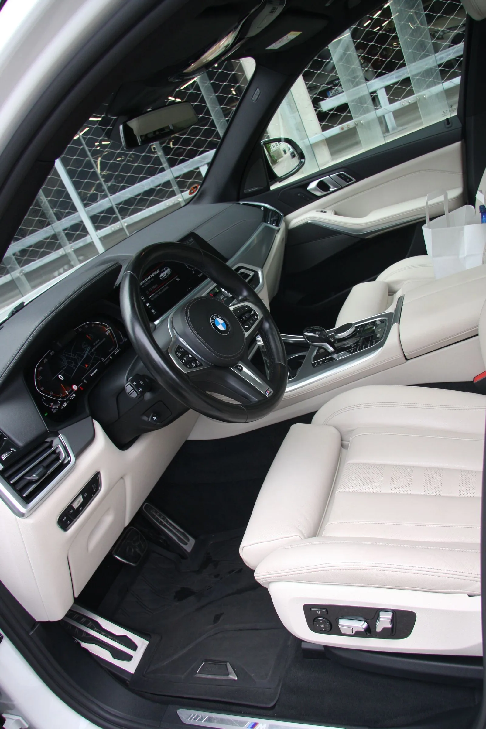 Clean light BMW interior, door and dashboard detail.