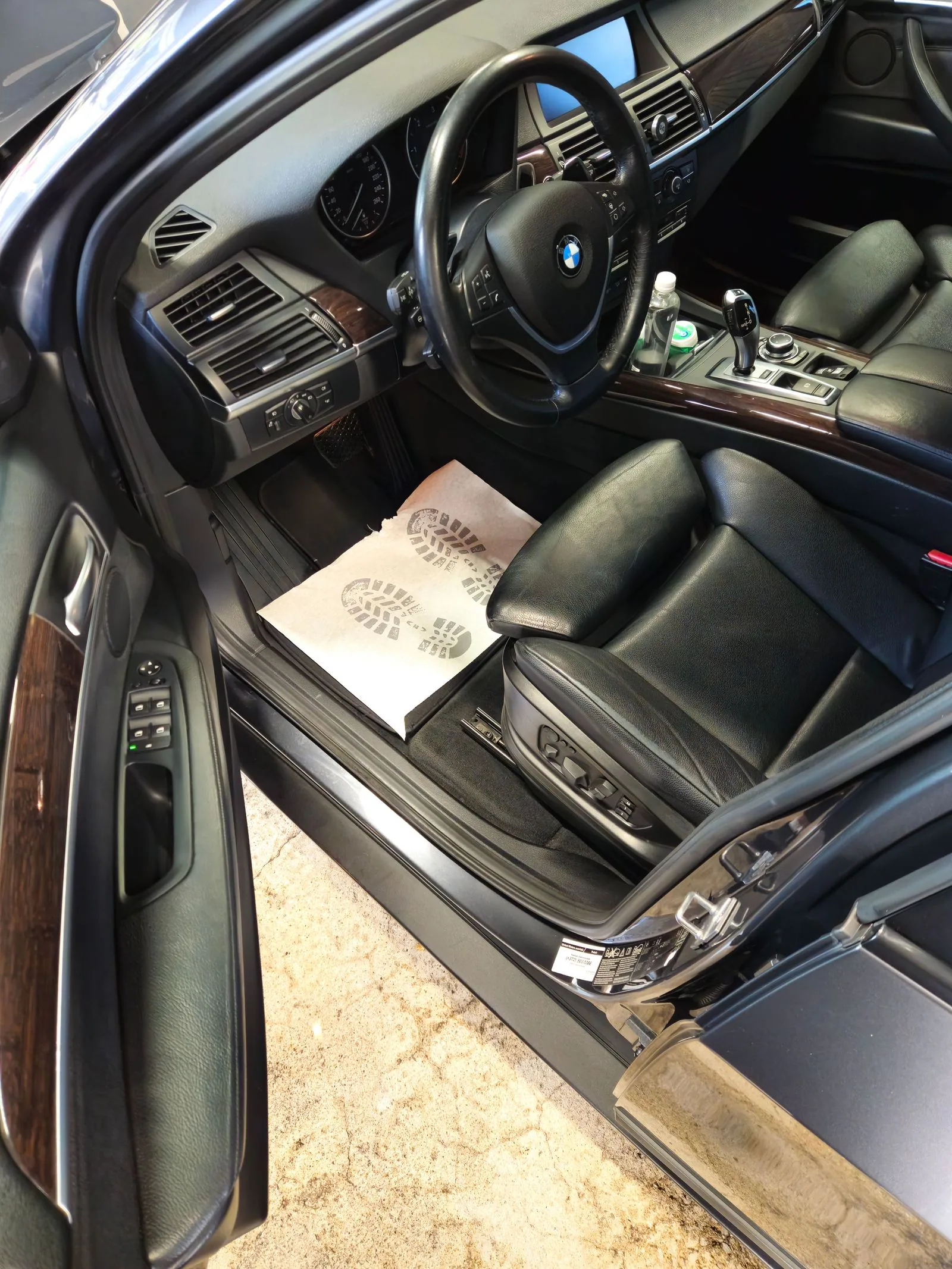 Clean black-leather driver's seat and door area.