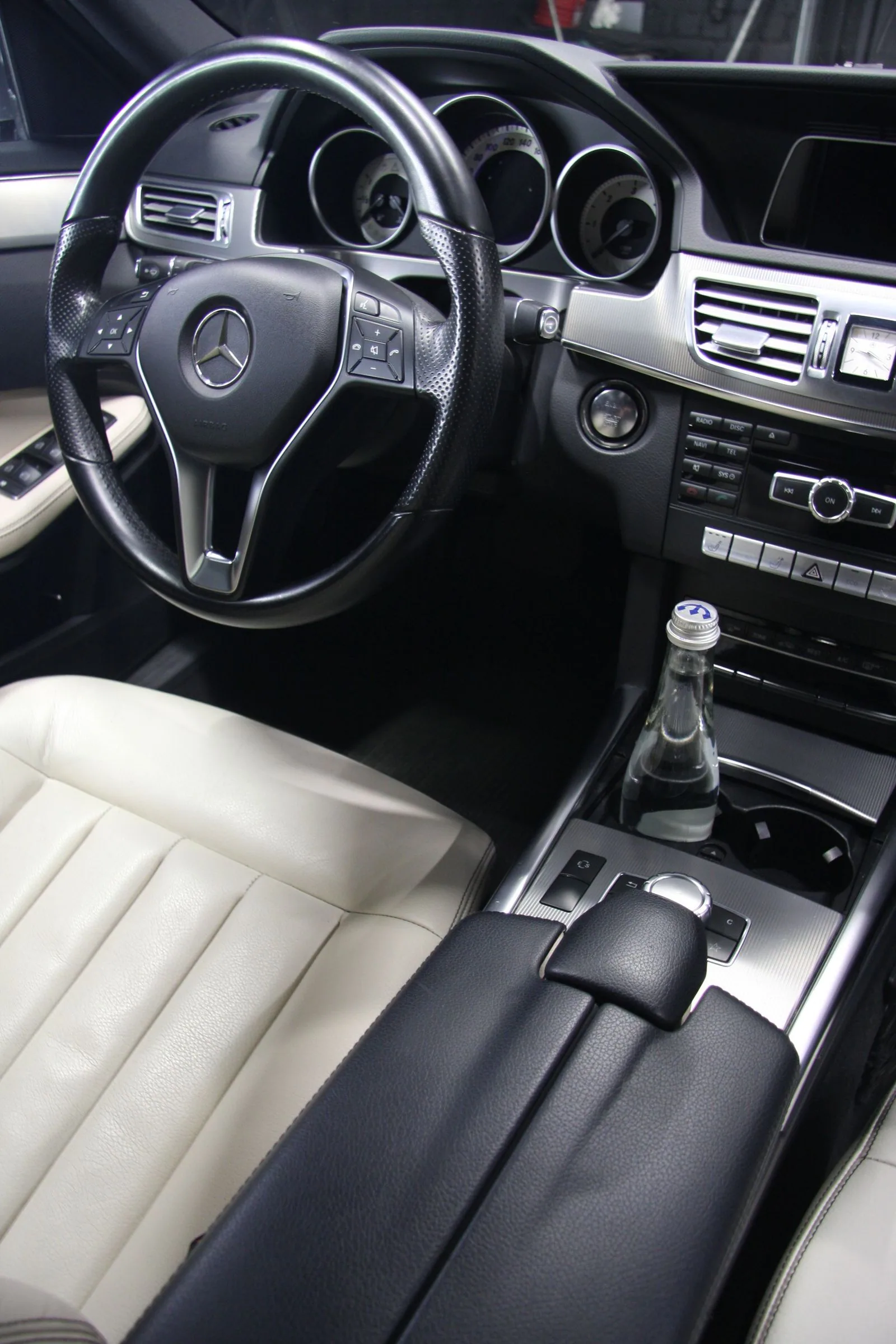 Clean driver's area with light leather upholstery.