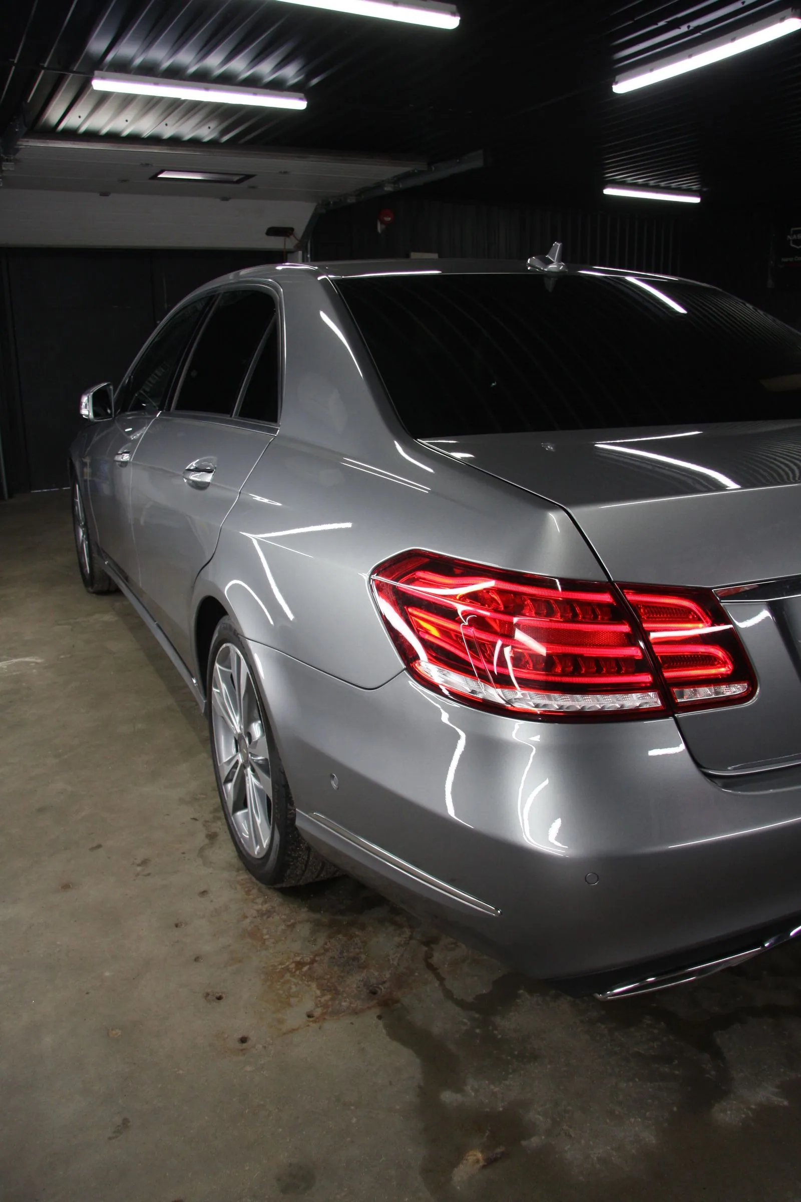 Clean rear quarter and glossy paintwork of a silver saloon.